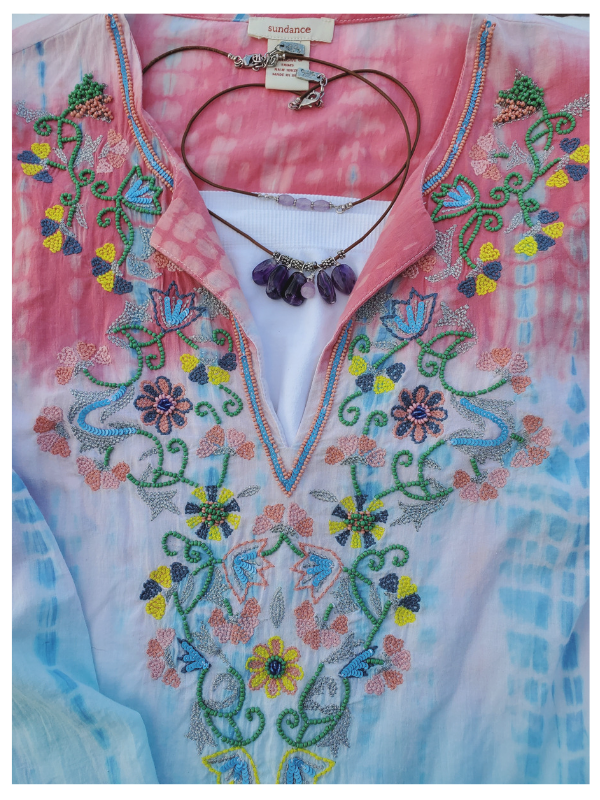 female outside with knotted scarf & layered necklaces